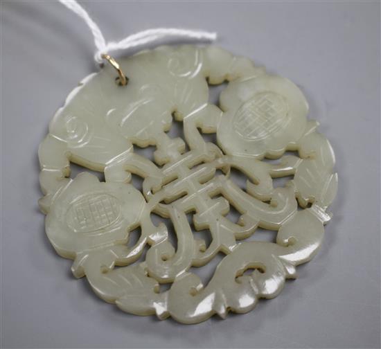 A Chinese pierced and carved pale celadon jade circular plaque pendant, 59mm, gross weight 23.5 grams.